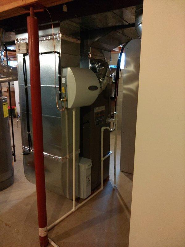 # HVAC Install - Complete System

Completed installation of a 90% AFUE gas furnace with 5-ton air conditioning system in residential basement mechanical room. Installed new air handler unit with integrated humidifier attachment on side-mounted cylindrical canister. Positioned equipment on concrete floor with proper clearances from existing utilities including fire sprinkler lines and water heater.

Ran supply and return ductwork from unit, incorporating both rigid metal and flexible ducting as required for proper airflow distribution. Connected refrigerant lines to outdoor condensing unit and performed evacuation of system. Charged air conditioning system with appropriate refrigerant type and quantity per manufacturer specifications.

Performed comprehensive system startup and testing procedures. Utilized digital manifold gauges to verify operating pressures and temperatures across the system. Recorded temperature differential readings showing proper system performance with evaporator 