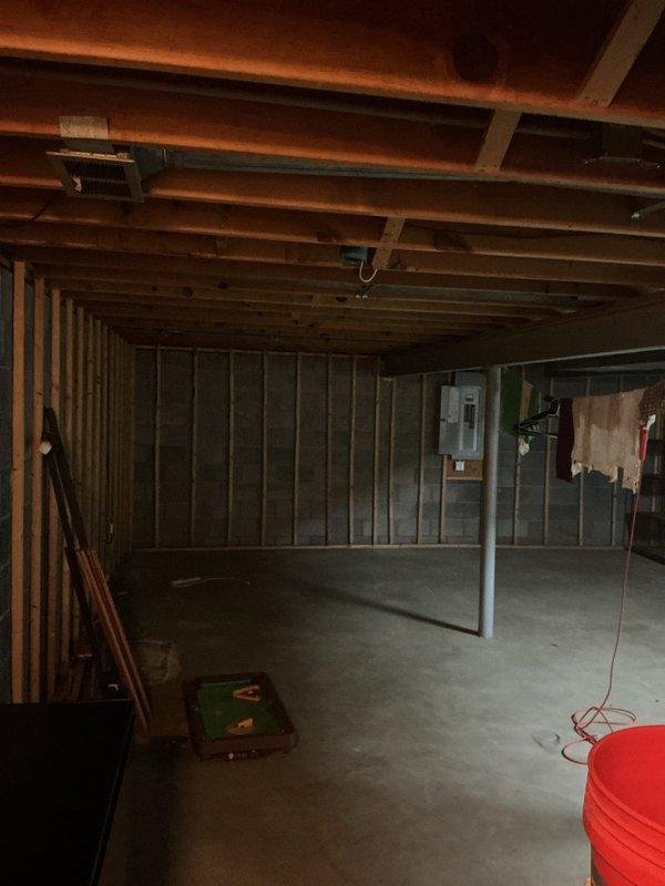 Conducted site assessment of unfinished basement electrical system to provide estimate for additional fixture installations and electrical work. Documented existing electrical panel configuration with multiple circuit breakers, assessed available capacity for new circuits, and evaluated current wiring infrastructure including conduit runs along ceiling joists. Identified optimal locations for potential new fixtures based on exposed framing structure and existing electrical pathways in preparation for detailed scope of work proposal.
