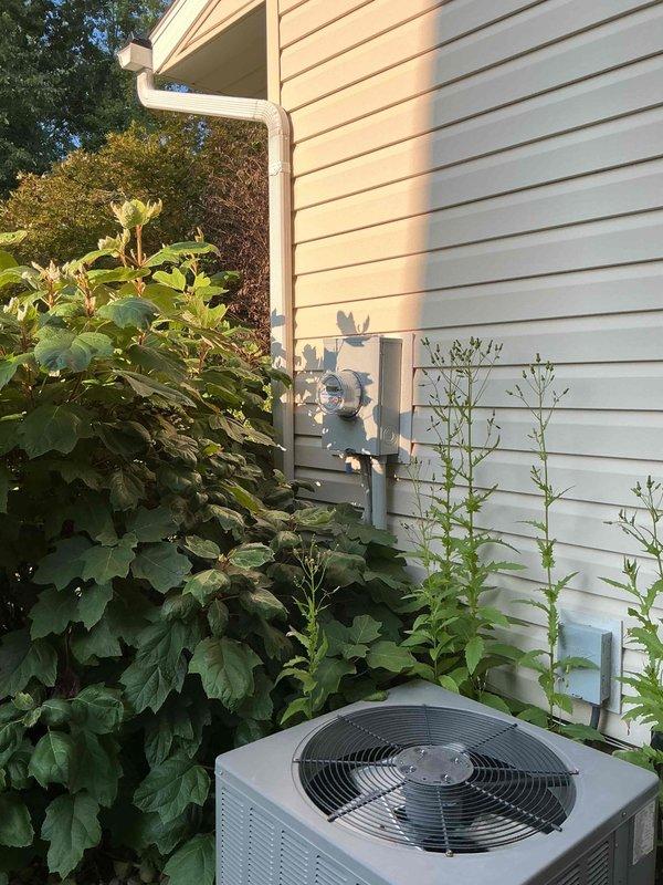 Completed scheduled maintenance visit on 12-year-old residential air conditioning system. Performed comprehensive inspection of indoor air handler unit and outdoor condenser unit, checked all electrical connections and refrigerant levels, cleaned condenser coils, and verified proper system operation. Noted vegetation encroachment around outdoor unit requiring clearance for optimal airflow and recommended ongoing maintenance to ensure continued efficient cooling performance.