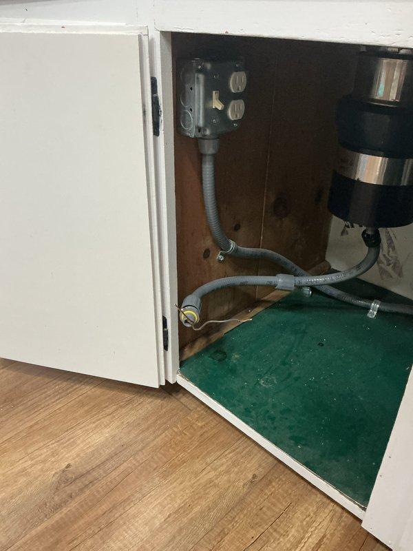 Hardwired garbage disposal unit to existing electrical circuit located beneath kitchen sink. Converted disposal from plug-in outlet connection to permanent electrical connection, utilizing existing wiring infrastructure that was previously installed for under-sink lighting circuit. Completed electrical installation in compliance with code requirements for hardwired appliance connections.