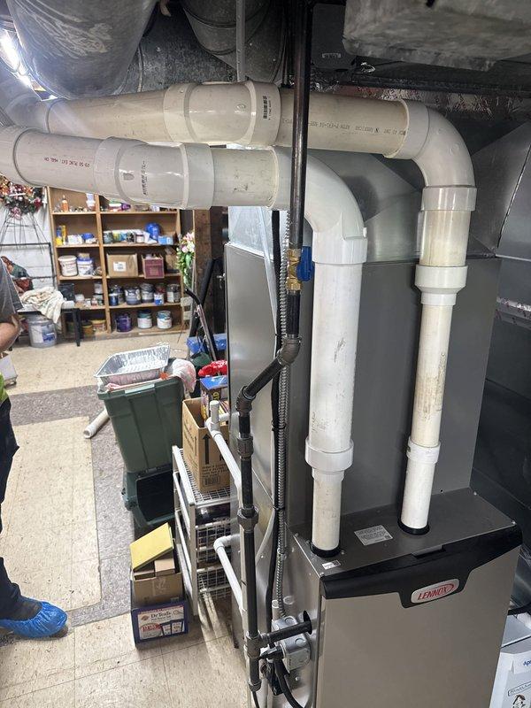 Failed initial inspection due to non-code-compliant cellular core piping installed on furnace exhaust run. Air conditioning system and carbon monoxide detector were properly installed to code. Job placed on hold pending approval for replacement of exhaust piping with code-approved PVC venting system, with scheduling to be coordinated for completion.