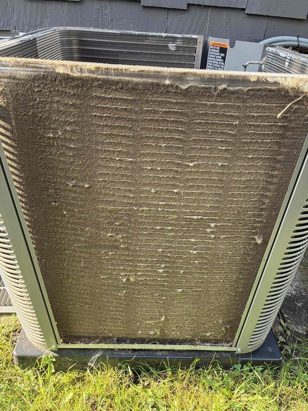 Completed annual maintenance on one-year-old air conditioning system. Performed comprehensive inspection of both indoor evaporator coil and outdoor condenser unit. Indoor evaporator coil showed moderate dust and debris accumulation on aluminum fins with more pronounced buildup on one side. Outdoor condenser unit exhibited heavy dirt and debris coating on coil surfaces, with thick layer of dust and grime obscuring fins throughout. Documented system condition through photographs. Verified refrigerant lines and connections. System operational at time of service completion.