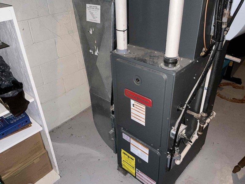 Responded to no cooling complaint on 21-year-old residential air conditioning and furnace system. Performed on-site assessment of existing HVAC equipment located in basement utility area, including dark gray furnace unit with dual white PVC venting and associated air conditioning components. Documented current system condition through photographic inspection, noting equipment age, configuration, and installation details. Provided comprehensive replacement estimate for complete HVAC system upgrade to address aging equipment and restore cooling functionality.
