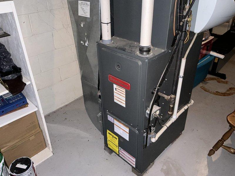 Responded to no cooling complaint on 21-year-old residential air conditioning and furnace system. Performed on-site assessment of existing HVAC equipment located in basement utility area, including dark gray furnace unit with dual white PVC venting and associated air conditioning components. Documented current system condition through photographic inspection, noting equipment age, configuration, and installation details. Provided comprehensive replacement estimate for complete HVAC system upgrade to address aging equipment and restore cooling functionality.