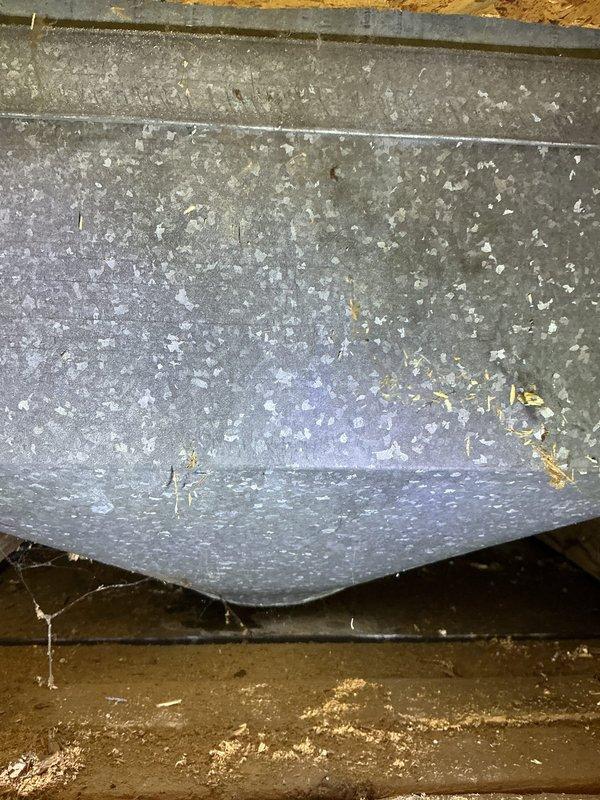 Responded to service call for water dripping from air duct near furnace. Upon inspection, discovered extensive condensation accumulation on metallic ductwork surfaces throughout the area, with visible water droplets covering the exterior of the ducts. Identified a separation point in the ductwork where sections had pulled apart, creating a gap that was allowing conditioned air to escape and contributing to moisture issues. The heavy condensation indicated significant temperature differential between the duct interior and ambient conditions in the utility space. Documented conditions with photographs showing the extent of moisture accumulation and structural separation in the ductwork system requiring repair to prevent continued water damage.