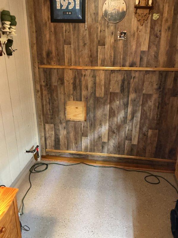 Completed installation of dehumidifier unit and wall-mounted heater in residential structure with rustic interior finishes. Unit currently configured for natural gas operation with notation that propane conversion will be required at future date per customer request.