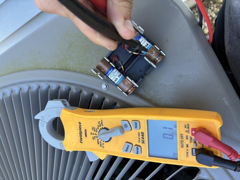 Responded to no cooling complaint on residential air conditioning system. Upon inspection, discovered failed dual run capacitor preventing compressor operation. Verified fuse status at control panel and tested electrical components with digital multimeter. Replaced defective capacitor and restored system to normal cooling operation.