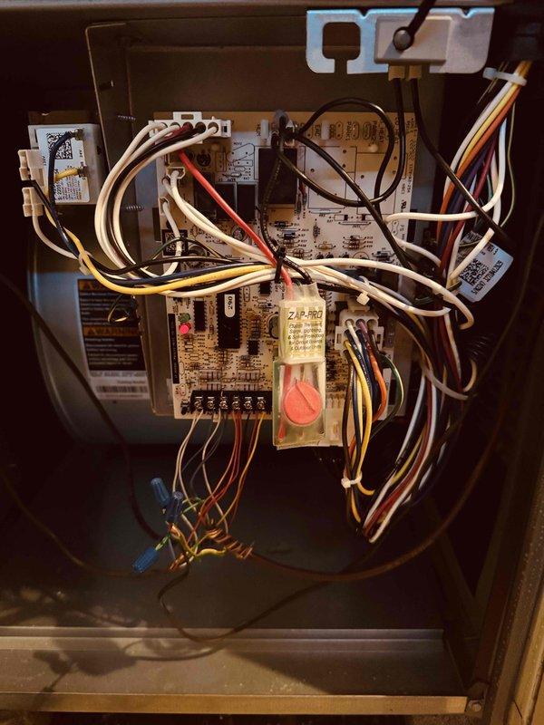 Responded to no cooling complaint on 20-year-old air conditioning system. Upon inspection, found heavily oxidized evaporator coil with significant tarnishing on copper tubing and deteriorated heat exchanger assembly. Evaluated control board and electrical components within air handler, noting existing wiring configuration and relay assembly. Documented current system condition with photographic evidence showing advanced age-related degradation of refrigerant coil and control system components for customer review and future service planning.