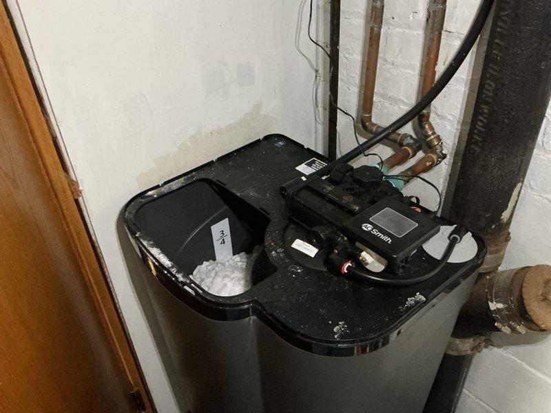 Responded to service call for water softener not cycling through salt properly despite being a newer unit. Upon inspection of the dual-tank water softening system, documented equipment condition including serial number 23251348639131 and assessed control unit functionality. Customer advised that repair services would not be provided for this particular unit, and estimate for new water softener replacement system was offered as the recommended solution.