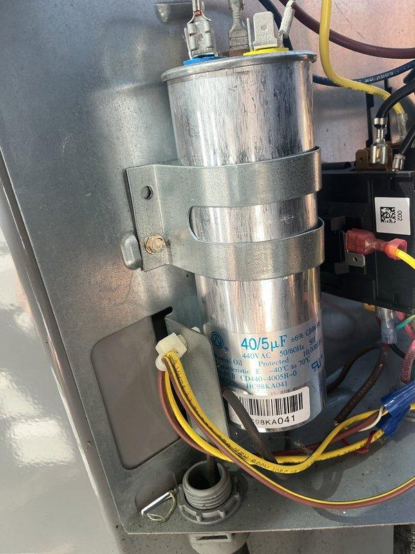 Completed MVP cooling maintenance visit on 3-year-old system. Inspected dual-run capacitor showing proper ratings of 40/5µF at 450V AC with all wire connections secure. Measured supply air temperature at 70°F and verified proper airflow through ductwork and insulation integrity in attic space.