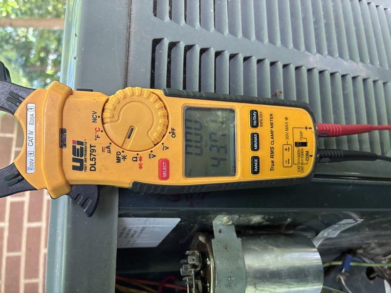 Completed preventive maintenance on 13-year-old air conditioning system. Performed electrical diagnostics using clamp meter, recording amperage readings at 83.7 amps. Inspected condenser unit components including compressor motor, capacitor, and electrical connections, noting age-appropriate wear and some corrosion on motor terminals but system operating within acceptable parameters.