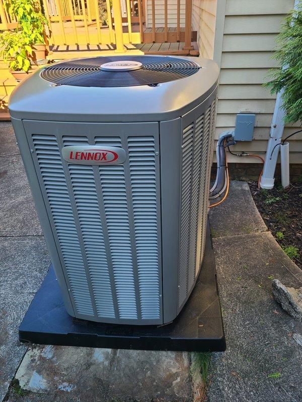 Completed installation of Lennox air conditioning condenser unit with matching evaporator coil. Unit was positioned on concrete pad with proper clearances, refrigerant lines were connected and insulated with gray foam insulation, service valves installed with protective caps, and electrical disconnect box mounted on exterior wall. All connections were properly secured, system was tested for proper operation, and installation meets manufacturer specifications for optimal performance.