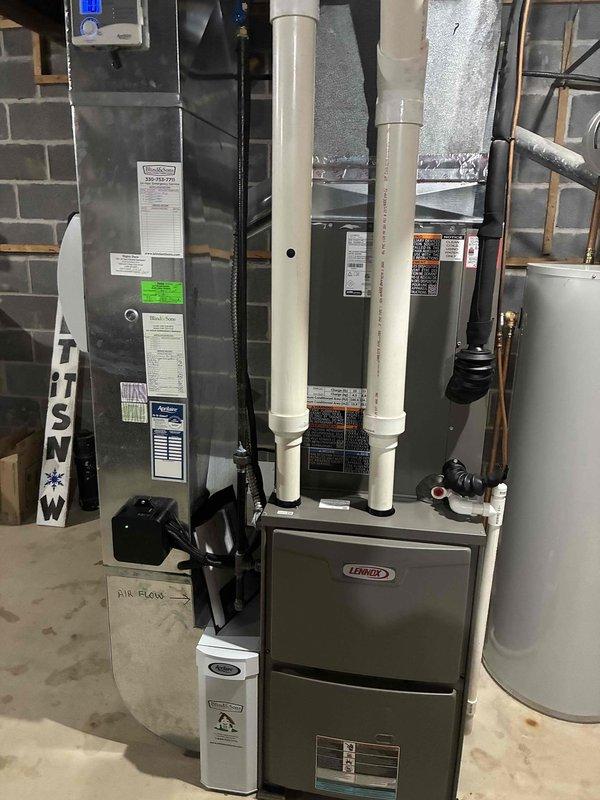 Performed preventative maintenance cooling visit on 3-year-old Lennox residential air conditioning system. Inspected outdoor condenser unit and indoor furnace/air handler system, verified proper operation of all components, and documented equipment condition with photos showing units in clean, well-maintained operational status.