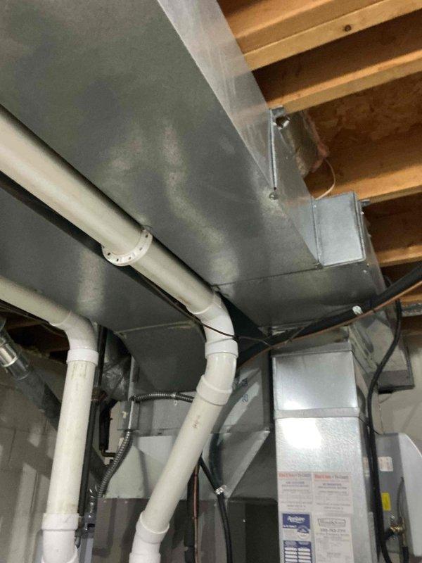 Completed annual maintenance on 3-year-old residential air conditioning system including standard inspection of indoor Lennox furnace, air handler, and associated components. Noted customer concern regarding mulch debris in outdoor intake pipes from lawn care activity; inspected exterior intake area and documented condition for potential follow-up service if airflow restriction develops.