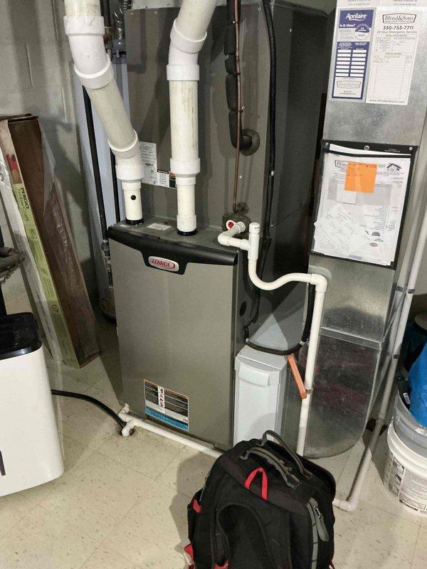 Completed annual maintenance on 3-year-old residential air conditioning system including standard inspection of indoor Lennox furnace, air handler, and associated components. Noted customer concern regarding mulch debris in outdoor intake pipes from lawn care activity; inspected exterior intake area and documented condition for potential follow-up service if airflow restriction develops.