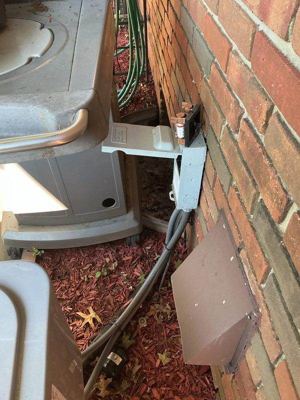 Completed routine maintenance visit on a 10-year-old residential air conditioning system. Performed standard cooling season inspection of outdoor condenser unit, verified proper operation of all components, and documented equipment condition through site photography. Unit found in serviceable condition with electrical disconnect box and refrigerant lines properly secured to exterior brick wall mounting location.