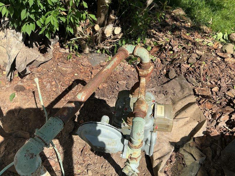 Responded to gas leak emergency where utility company had shut off gas service to property. Performed comprehensive diagnostic inspection of exterior gas line system and identified compromised piping requiring repair. Documented existing conditions of weathered gas piping, valves, and meter assembly showing significant corrosion and aging. Assessed gas line configuration and prepared repair specifications to restore safe gas service to residence.