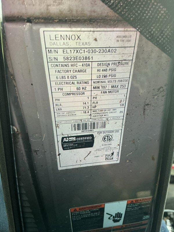 Completed MVP Cooling Visit on a 2-year-old Lennox EL17XC1-030-230A02 system containing HFC-410A refrigerant with a factory charge of 6 lbs 8 oz. Performed comprehensive maintenance inspection of both indoor and outdoor units. Verified electrical specifications are within acceptable parameters (208/230V nominal, MIN 197, MAX 253). Inspected outdoor condenser unit positioned on concrete pad, noting environmental debris accumulation and vegetation growth in surrounding area. Evaluated wall-mounted electrical disconnect box and associated conduit connections for proper operation. Documented equipment specifications including compressor ratings and fan motor specifications (0.7 FLA, 1/8 HP). Recommended installation of surge protector on motherboard to safeguard against electrical surges from home power supply or furnace-generated fluctuations. System operational and performing to manufacturer specifications upon completion of maintenance visit.