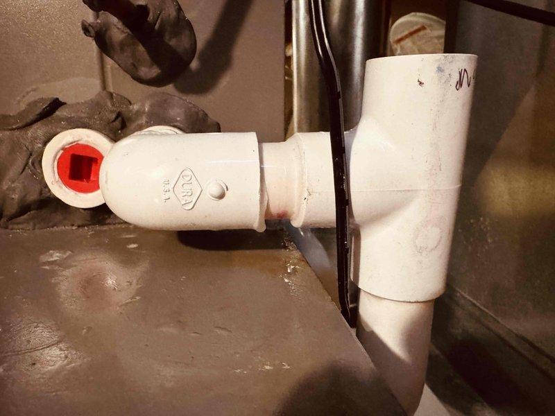 Responded to warranty call for PVC condensate drain leak on HVAC system. Inspected drainage assembly and identified leak at T-junction fitting, removed defective connection, cleaned and prepped pipe surfaces, and installed new PVC fitting with proper primer and cement application. Verified system is draining properly with no active leaks and left installation secure and operational.