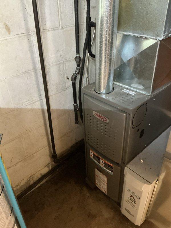Responded to service call for liquid discharge from basement AC unit at red plug location. Upon arrival, inspected Lennox HVAC system in basement and outdoor condensing unit. Located condensate drain plug on evaporator coil assembly where water was actively leaking. Cleared blocked condensate drain line, verified proper drainage flow, and secured drain plug. Tested system operation to confirm no further water discharge. Unit operating normally with proper condensation removal through drain system.
