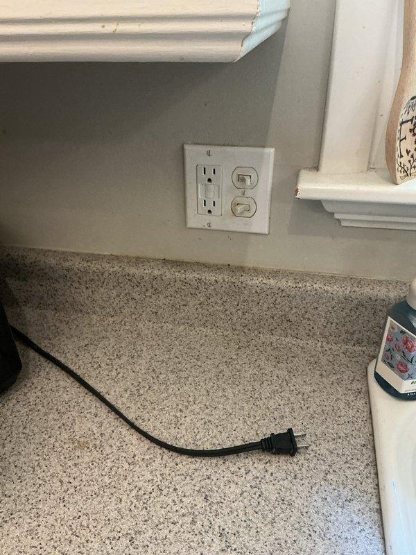 Responded to a non-functioning GFI outlet near the kitchen sink that was not responding to breaker resets. Upon arrival, inspected the outlet and switch combination plate mounted on the wall above the granite countertop. Removed the cover plate and pulled the devices forward to access the electrical box and internal wiring connections. Identified faulty wiring connections within the junction box as the root cause of the power loss. Verified all wire connections including hot, neutral, and ground conductors, ensuring proper termination and secure attachment to the GFI receptacle. Tested the circuit for proper voltage and ground fault protection functionality. Reinstalled the outlet and switch devices, secured them to the wall box, and replaced the cover plate. Confirmed restoration of power to the GFI outlet and verified proper reset functionality.