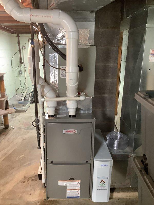 Completed installation of a Lennox 90% AFUE furnace in basement mechanical room. Installed complete PVC venting system with proper pitch and support, configured all ductwork connections including supply and return plenums with insulated flexible duct runs, and established all necessary gas and electrical connections per manufacturer specifications. Installed Kidde carbon monoxide alarm in accordance with safety codes to provide proper monitoring for combustion appliances.