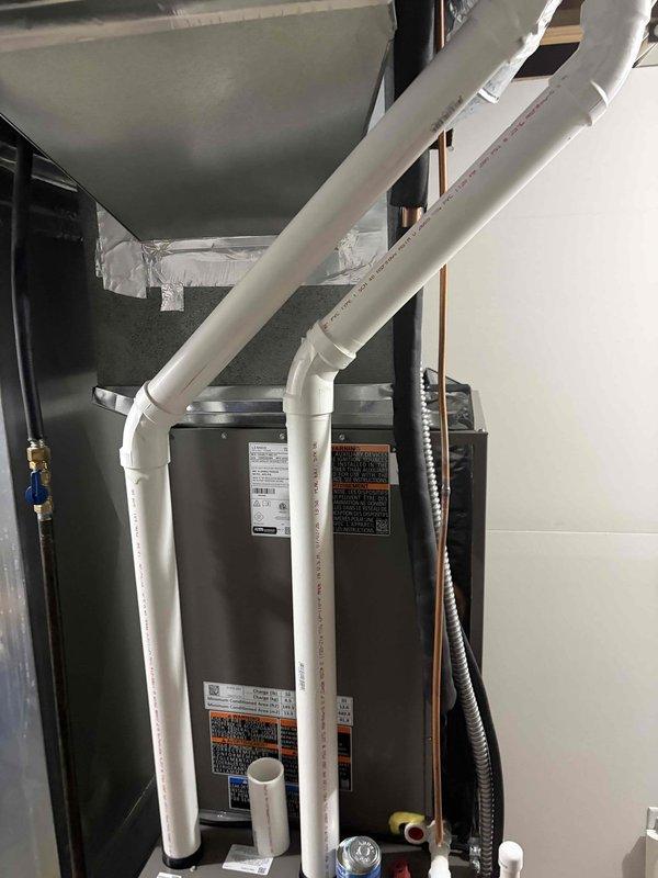 # HVAC Complete System Installation

Successfully completed installation of a high-efficiency 90% AFUE furnace and air conditioning system. Installed new furnace unit in mechanical room with proper clearances and mounting. Routed and secured white PVC intake and exhaust venting through ceiling cavity using manufacturer-approved materials and support methods. All PVC pipes properly secured with UV-resistant zip ties at appropriate intervals and supported with metal mounting brackets to prevent sagging and ensure code compliance.

Connected gas supply line using flexible corrugated tubing with proper shutoff valve installation. Installed and terminated all required electrical connections to unit, ensuring proper grounding and circuit protection. Configured condensate drainage system with appropriate trap installation and PVC piping to approved drain location.

Completed all refrigerant line connections between indoor and outdoor units with proper insulation and support. Pressure tested s