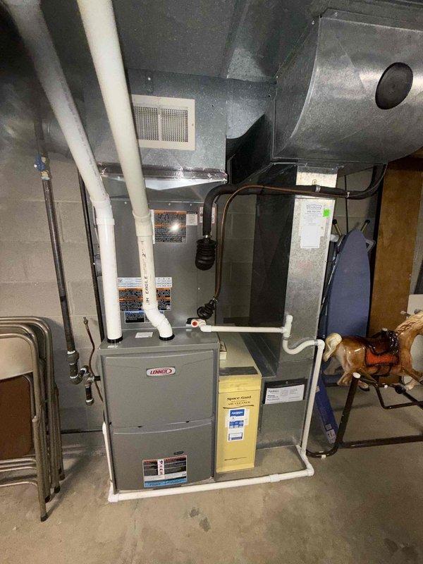 Completed MVP cooling maintenance visit on residential Lennox HVAC system. Performed comprehensive inspection of furnace unit, air handler, and associated ductwork in basement installation. Examined blower assembly and verified proper blade condition and cleanliness. Inspected condensate drain lines, PVC venting system, and all interconnected piping for proper operation. Checked refrigerant lines, electrical connections, and ductwork integrity. Verified system components are operating within manufacturer specifications. All equipment found in good working condition with no immediate service needs identified. System ready for continued operation.