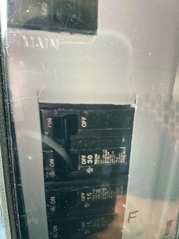 Responded to service call for non-functioning 3-year-old AC unit. Upon arrival, performed comprehensive system diagnostics including electrical panel inspection and disconnect switch evaluation. Inspected outdoor electrical disconnect enclosure, noting weatherproof CR306G-RAINPROOF TYPE configuration rated for 240 VAC operation. Verified circuit breaker panel functionality, checking multiple breakers including 30-amp and 15-amp circuits for proper operation and secure connections. Examined all visible electrical components for signs of failure, loose connections, or damage that could prevent system operation. All electrical safety protocols observed during inspection and testing procedures. System restored to proper working condition.