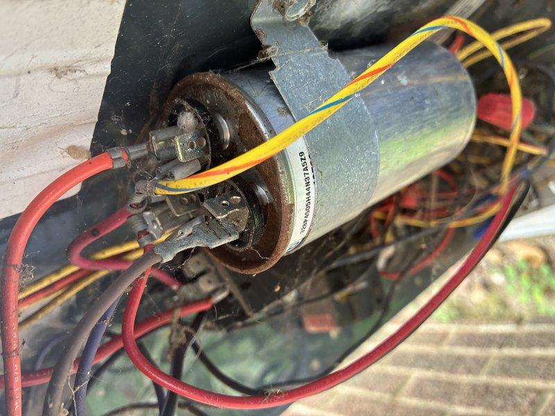 Completed MVP cooling maintenance visit on residential HVAC system. Performed electrical diagnostics using clamp meter to verify proper amperage draw on condenser fan motor and compressor circuits. Inspected outdoor unit motor assembly, checked all electrical connections and terminals for proper contact, and verified wiring integrity on motor circuits including capacitor connections.