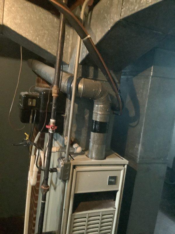 Provided comprehensive estimate for complete HVAC system replacement of aging equipment including a 1983 gravity furnace and 2001 air conditioning unit. Assessed existing basement installation with outdated gravity heating system, evaluated current ductwork configuration, refrigerant line routing, gas piping, and electrical connections to determine scope of replacement work required for modern forced-air system upgrade.