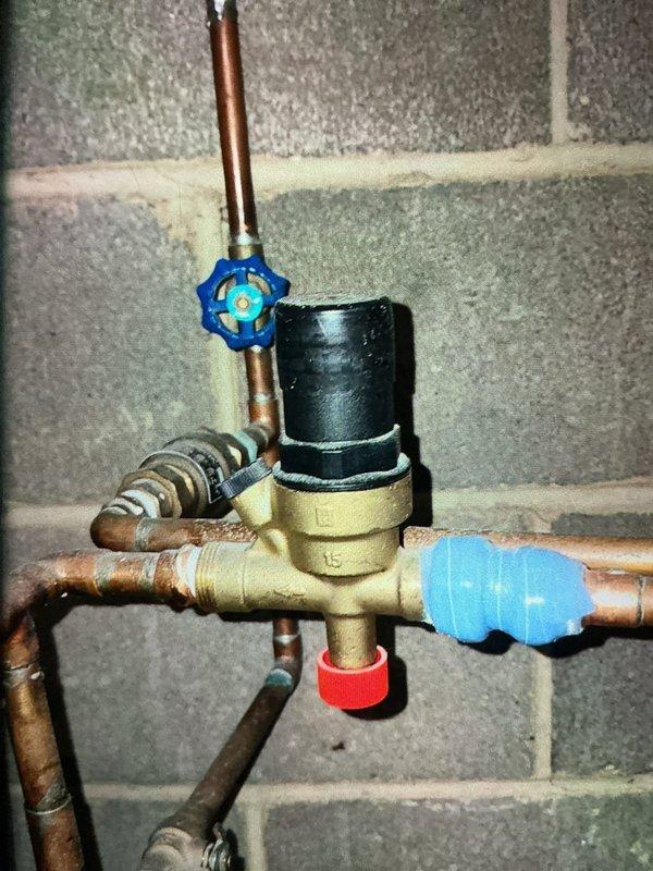 Completed MVP furnace maintenance inspection and system evaluation. Documented water supply plumbing assembly with copper piping, brass fittings, and shutoff valves, confirming proper configuration and connections. Inspected temperature and pressure gauge readings on heating system, verifying operational parameters within normal range with temperature and PSI measurements displaying correctly on analog gauge face.