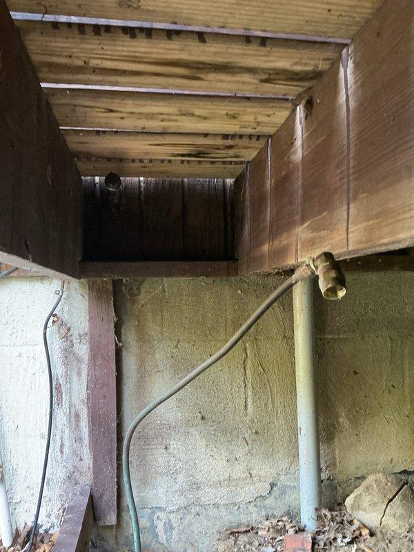 Responded to service call for gas line disconnection in basement. Located and isolated the gas supply line that previously fed a built-in grill. Installed brass ball valve with shutoff capability on the existing galvanized gas pipe run between floor joists. Properly capped the line downstream of the shutoff valve to permanently seal the gas supply, ensuring no gas flow to the disconnected grill appliance. Verified secure mounting of all components to structural framing and confirmed proper installation per gas code requirements.