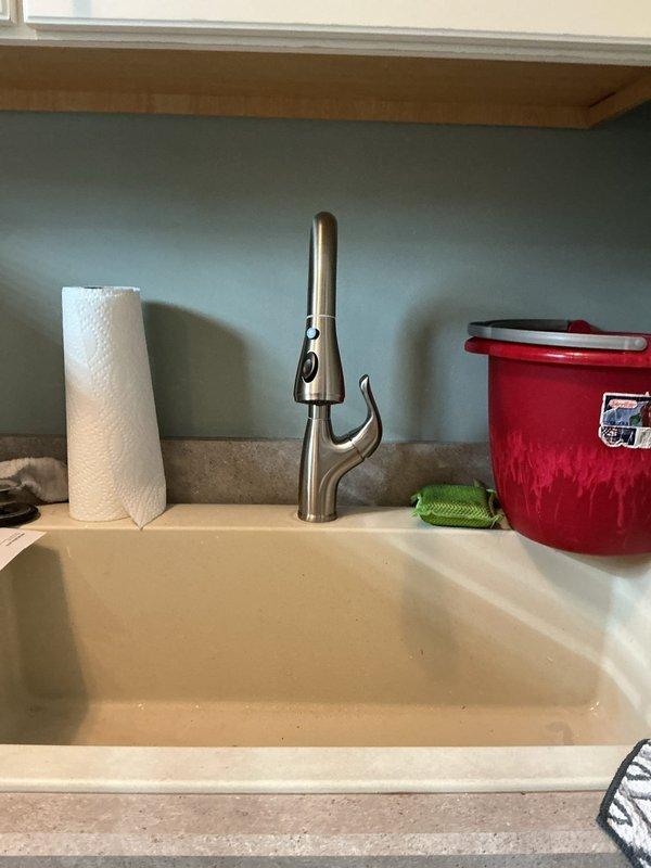Replaced existing laundry faucet with new single-hole kitchen-style faucet in first floor laundry room. Disconnected old water supply lines, removed previous fixture, installed new faucet assembly with braided stainless steel supply lines, and reconnected to existing shut-off valves. Verified proper water flow and tested for leaks upon completion.