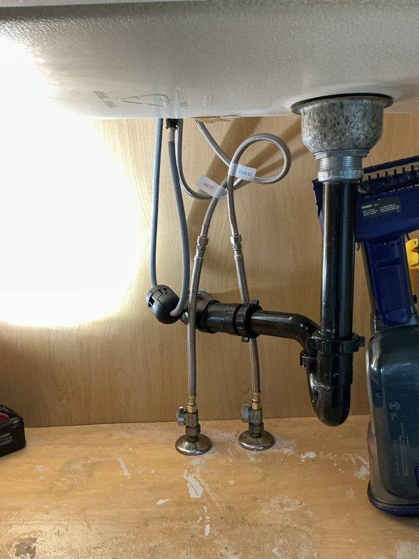 Replaced existing laundry faucet with new single-hole kitchen-style faucet in first floor laundry room. Disconnected old water supply lines, removed previous fixture, installed new faucet assembly with braided stainless steel supply lines, and reconnected to existing shut-off valves. Verified proper water flow and tested for leaks upon completion.