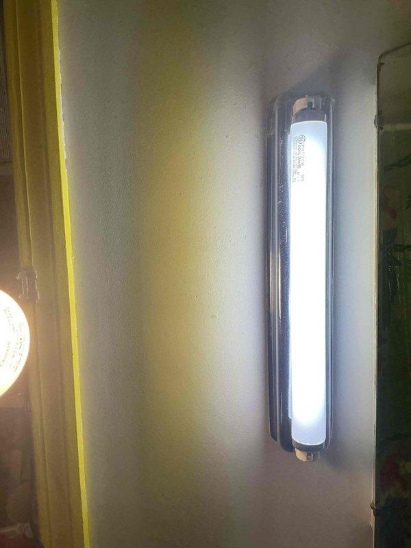 Responded to service call for malfunctioning fluorescent light fixtures in bathroom. Upon inspection, found one side required lamp replacement while the opposite side needed both new lamp and ballast repair. Replaced defective fluorescent tubes on both fixtures and repaired faulty ballast to restore proper operation. All lighting fixtures tested and verified operational upon completion.