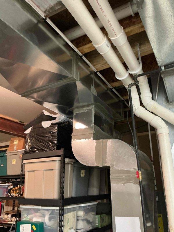Completed MVP cooling maintenance visit on residential Lennox HVAC system located in basement utility area. Performed comprehensive inspection of furnace unit, verified proper operation of intake and exhaust venting through white PVC pipes, and checked all refrigerant lines and connections. Examined condensate pump operation and drainage system functionality. Inspected ductwork including flexible metal ducts and rectangular plenum connections for proper sealing and airflow. All system components operating within normal parameters with no issues identified during this recurring maintenance service.