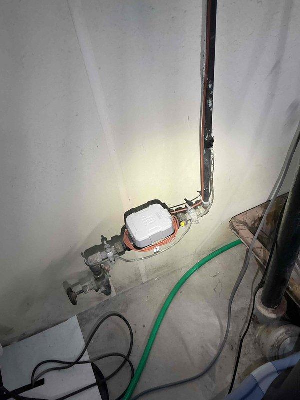 Installed whole-house surge protection system for 1949-era residential property with mixed grounding infrastructure. Mounted surge suppressor device at main service entrance near meter location and established proper grounding connection to existing copper water line in basement utility area. Evaluated existing 20-circuit electrical panel configuration and verified GFCI circuit placement to ensure compatibility with new surge protection equipment without requiring panel modifications.