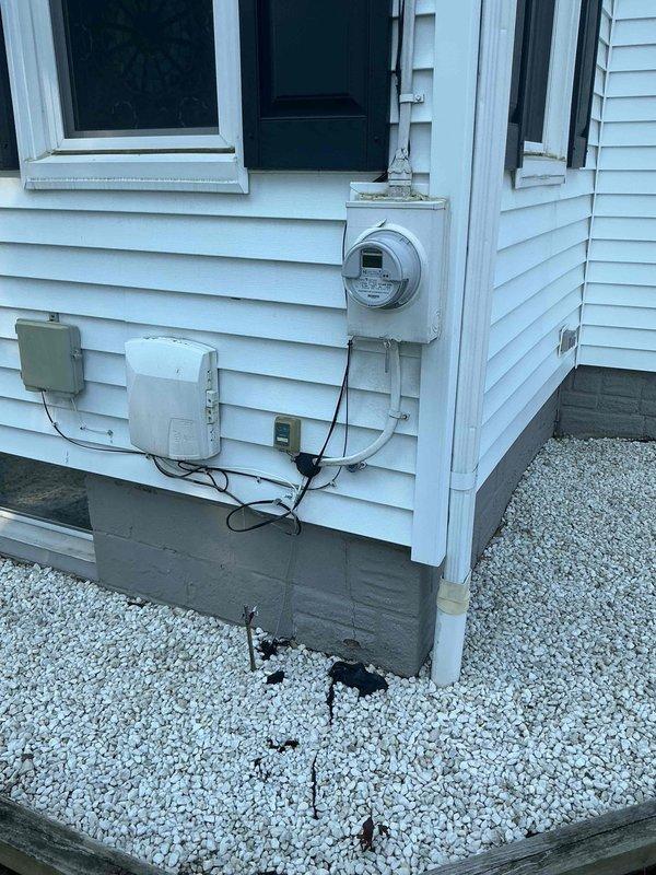 Installed whole-house surge protection system for 1949-era residential property with mixed grounding infrastructure. Mounted surge suppressor device at main service entrance near meter location and established proper grounding connection to existing copper water line in basement utility area. Evaluated existing 20-circuit electrical panel configuration and verified GFCI circuit placement to ensure compatibility with new surge protection equipment without requiring panel modifications.