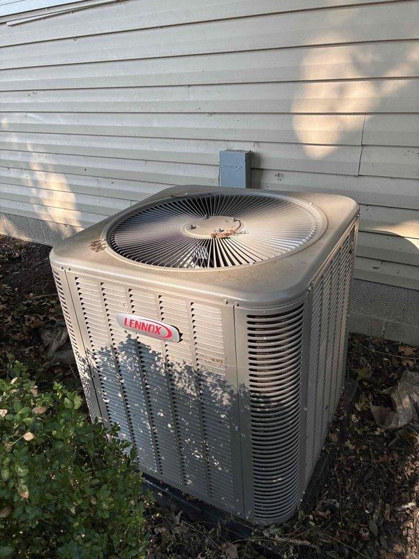 Completed comprehensive MVP air conditioning maintenance service on residential Lennox cooling system and furnace. Performed thorough inspection of outdoor condensing unit, which showed significant weathering and debris accumulation on exterior surfaces and coil fins. Cleaned condenser coils, removed leaves and organic debris from unit base, and verified proper airflow through louvered panels. Inspected indoor furnace system in basement, checked electrical connections and control components, and verified proper operation of blower assembly. Documented equipment condition with photos showing both outdoor AC unit on concrete pad and indoor furnace installation with ductwork connections. All system components tested and confirmed operational for continued cooling season performance.