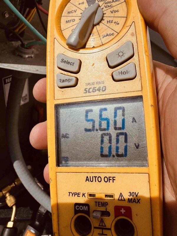 Completed MVP recurring cooling maintenance visit on residential HVAC system. Performed diagnostic testing using digital multimeter, recording amp draw reading of 560A and voltage measurement of 29.3V at outdoor condensing unit. All electrical parameters verified within normal operating range, and system confirmed operational with 0.0 secondary reading indicating proper functionality.