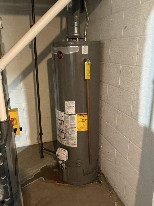Responded to service call for leaking water heater in basement location. Upon inspection, assessed existing Reliance brand tanked water heater showing signs of failure and active leak at base. Documented current installation including copper supply lines, venting configuration, and basement utility room placement against cinder block wall. Provided comprehensive estimate for complete water heater replacement with new unit and necessary installation materials. Photographed existing equipment and plumbing connections for replacement specifications.