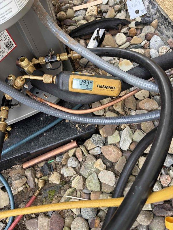 Completed installation of new air conditioning condenser unit and evaporator coil system. Installed outdoor condensing unit on landscaping rock pad with proper refrigerant line connections, verified system pressures and temperatures using diagnostic equipment with readings confirming proper charge levels at 393 PSI. Connected indoor air handler unit with appropriate electrical wiring, PVC condensate drainage lines, and refrigerant piping, ensuring all manufacturer specifications and safety labels were properly affixed and all connections were secure and leak-free.