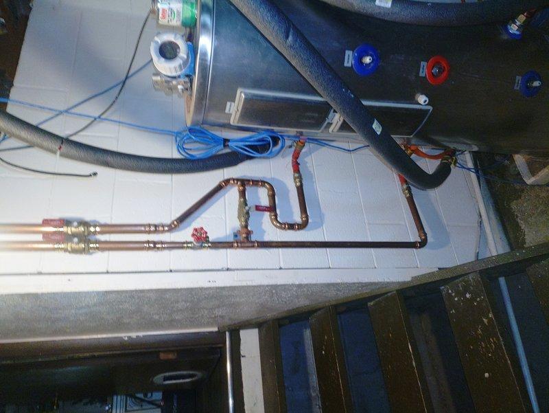 Responded to service call for furnace leaking issue on unit installed in March. Upon inspection, identified leak in furnace system and photographed installation showing HVAC components including pressure gauges, expansion tank, refrigerant lines, and associated mechanical connections. Documented PCB-related concerns and overall system configuration for further evaluation and repair recommendations.