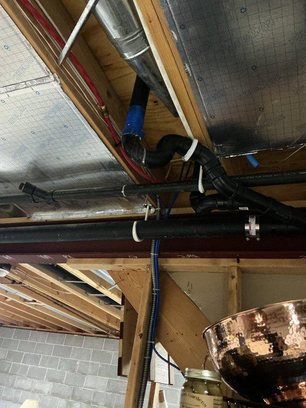 Responded to service call for dripping drainage trap in basement area. Upon inspection, located the source of the drip in the overhead plumbing system near HVAC components and ductwork. Assessed the drainage trap assembly, tightened connections, and verified proper sealing to eliminate the leak. Confirmed no active dripping and ensured all plumbing connections in the affected area were secure and functioning properly.