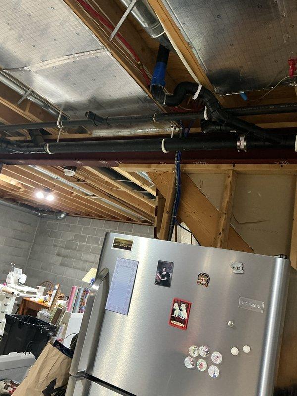 Responded to service call for dripping drainage trap in basement area. Upon inspection, located the source of the drip in the overhead plumbing system near HVAC components and ductwork. Assessed the drainage trap assembly, tightened connections, and verified proper sealing to eliminate the leak. Confirmed no active dripping and ensured all plumbing connections in the affected area were secure and functioning properly.