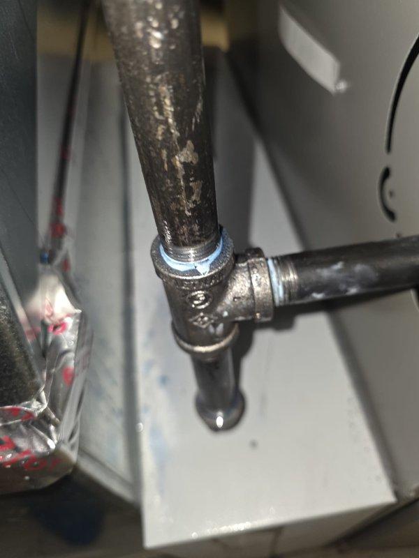 Responded to failed inspection due to active gas leak detected at pipe union connection. Shut off gas supply to equipment for safety. Documented corroded and deteriorated threaded union connection showing visible wear and surface degradation. Equipment remains offline pending repair of gas leak at union fitting.