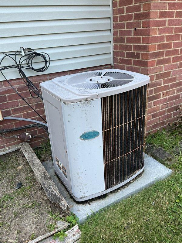 Responded to service call for 20+ year old air conditioning unit producing abnormal operational noises. Upon arrival, performed visual inspection of outdoor condensing unit and associated components. Identified heavily corroded suction line service valve and filter drier assembly showing significant rust deterioration due to prolonged weather exposure. Exterior cabinet panels exhibited surface weathering and minor rust staining consistent with unit age. Conducted operational assessment to identify noise source and verified proper fan motor operation. Documented existing corrosion on refrigerant line components and overall equipment condition through photographic evidence for customer records.