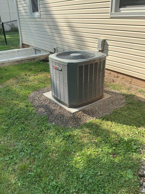 Leveled outdoor air conditioning condenser unit using gravel and hand jack equipment. The concrete pad supporting the unit was adjusted to ensure proper positioning and stability. Gravel material was utilized to provide adequate drainage and support beneath the equipment, restoring the installation to manufacturer specifications.
