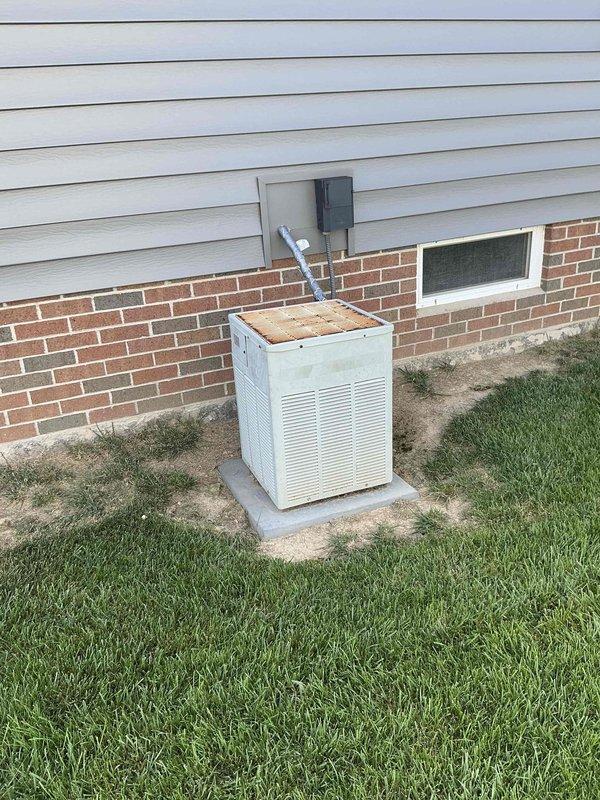 Completed comprehensive estimate for full HVAC system replacement of existing 30-year-old Trane XE 80 furnace and outdoor condensing unit. Assessed basement furnace installation including ductwork configuration and exterior condenser unit positioned on concrete pad, documenting current system condition and equipment specifications for replacement proposal.
